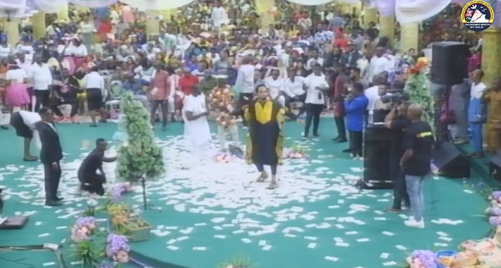 [VIDEO]: Members Rain Wads Of Naira On Pastor Odumeje During Thanksgiving Service | MarvelTvUpdates