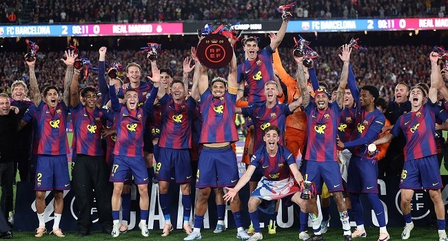 Barcelona's team celebrates winning the 2025-2026 Spanish League after the Spanish league football match between FC Barcelona and Real Madrid CF at Camp Nou Stadium in Barcelona on May 10, 2026. (Photo by Josep LAGO / AFP)